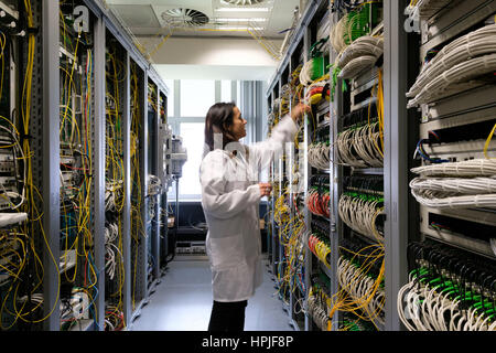 Data center technician working in the server room Stock Photo