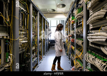 Data center technician working in the server room Stock Photo