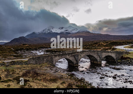 Snowcapped Cuillin Hills over the old bridge at Sligachan, shrouded in clouds, on the Isle of Skye, Scotland. Stock Photo