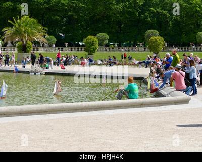 Watching Toy Boats, Garden Basin, Jardin du Luxembourg, Paris, France Stock Photo