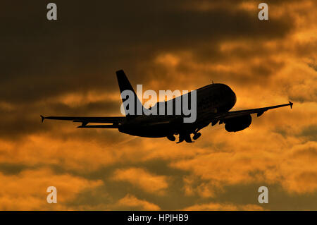 Air Serbia, national airline of Serbia (49% owned by Etihad Airways) Airbus A319 aircraft taking off in sunset Stock Photo