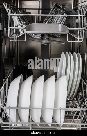 Clean dishes and accessories in dishwasher after washing Stock