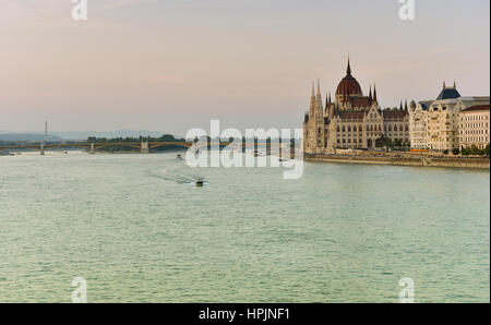 Budapest parliament at sunset near the Danube river Stock Photo