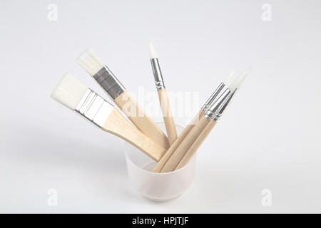 White paintbrushes with wooden handle in jar  clear background Stock Photo