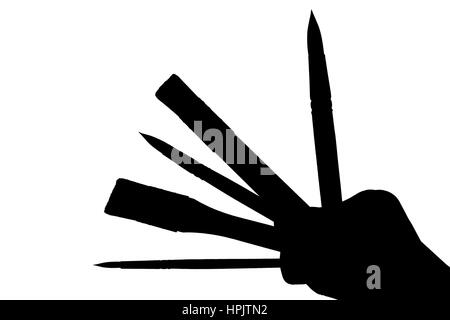 Paint brushes in the hand backlit isolated Stock Photo