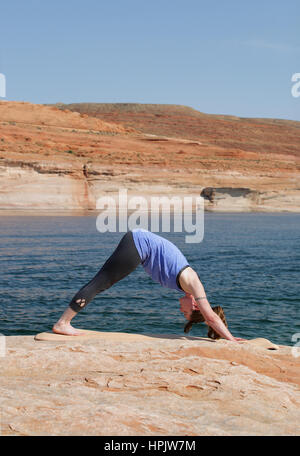 Young woman practicing downward facing tree asana in yoga studio. Adho  Mukha Vrksasana pose Stock Photo - Alamy