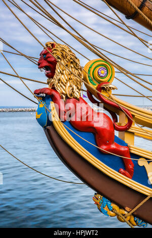 A close-up shot of a bright red lion nautical figurehead on a vintage sailing ship at MacMillan Pier in Provincetown, Massachusetts Stock Photo