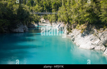 Hokitika, West Coast, New Zealand. View over the turquoise waters of the Hokitika River to swing bridge spanning the Hokitika Gorge. Stock Photo