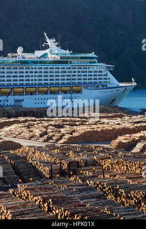 Picton, Marlborough, New Zealand. The Royal Caribbean cruise ship Voyager of the Seas moored in Shakespeare Bay, vast timber yard in foreground. Stock Photo