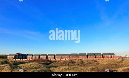 Row of new semi detached houses against blue sky Stock Photo