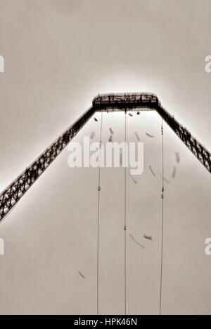 Movement of starlings against metal structure Stock Photo
