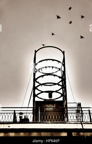 .Movement of starlings against metal structure Stock Photo