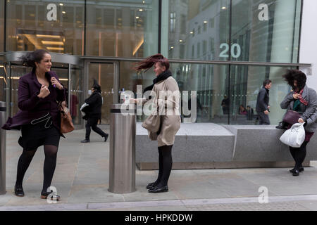 London, UK. 23rd February 2017. As Storm Doris blows across the UK, pedestrians on Fenchurch Street, brave the high winds funneled through the narrow streets, squeezed between the tall buildings of financial and insurance institutions in the City of London, on 23rd February 2017. Strong winds have led to flight cancellations and road and rail disruption across much of Britain. Thousands of homes have been left without power in Northern Ireland, Wales, Scotland and northern England. Richard Baker/Alamy Live News Stock Photo