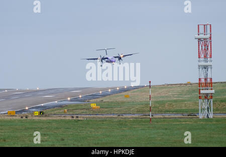 Leeds and Bradford Airport, West Yorkshire. UK. Thursday 23rd February 2017. Flybe turboprop passenger flight coming to land in strong cross winds at the UK's highest airport- Leeds Bradford. Credit: Ian Wray/Alamy Live News Stock Photo