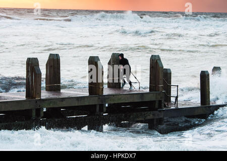 Aberystwyth Wales UK, Thursday 23 Feb 2017 UK Weather: Teenagers on the jetty in Aberystwyth playing a risky game of dodging the waves in the aftermath of Storm Doris was the fourth named storm of the winter, and was classified as a ‘weather bomb' (explosive cyclogenesis) by the Met Office Photo Credit: keith morris/Alamy Live News Stock Photo