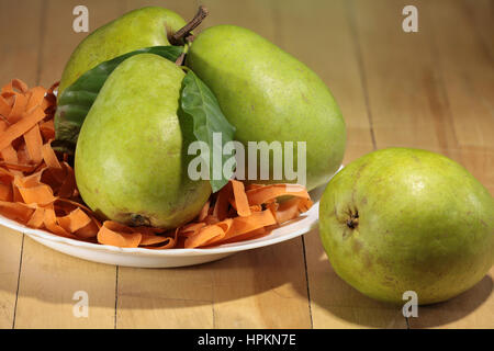 large ripe pears in the plate on the table Stock Photo