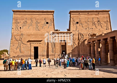 Groups of tourists in front of main entrance of Philae Temple, or Temple of Isis on Philae Island Stock Photo