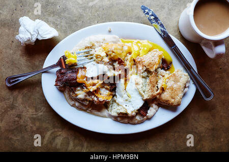 Southern Decadence - Buttermilk biscuit, chicken fried chicken, bacon, cheddar, country sausage gravy, sunny side up egg $13.95 Stock Photo