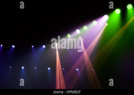 Stage lights on concert. Lighting equipment with multi-colored beams. Stock Photo