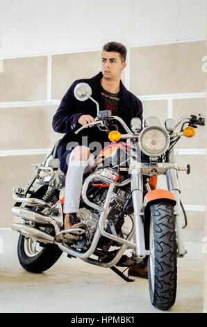 Handsome fashion man sitting on classical motorcycle. Stock Photo