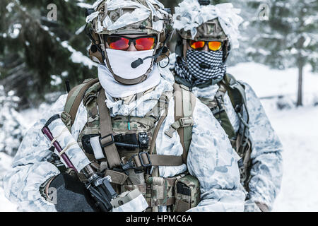 Soldiers in winter forest Stock Photo