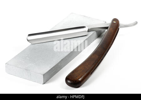 straight razor with honing stone isolated on white background Stock Photo