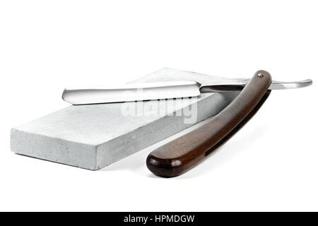 straight razor with honing stone isolated on white background Stock Photo