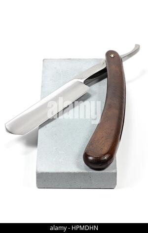 straight razor with honing stone isolated on white background Stock Photo