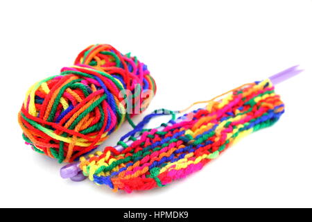 Bright multi-colored colourful knitting wool or yarn with knitting needles on white background Stock Photo