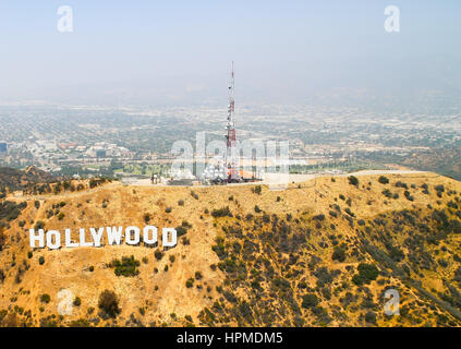 Los Angeles, USA - May 27, 2015: Aerial view of the Hollywood Sign on Mount Lee, on top of the mountain several antennas, in the back Warner Bros. Stu Stock Photo