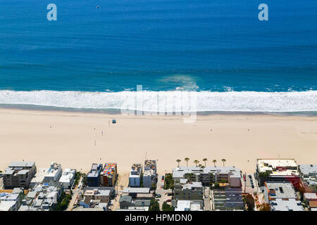 Los Angeles, USA - May 27, 2015: Part of the beach in Venice with residential buildings facing the beach and the ocean. There are hardly any people on Stock Photo