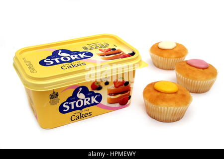 Camberley, UK - Feb 22nd 2017: A tub of Stork Cakes margarine, with three cupcakes or fairy cakes. Stork has been an iconic brand in the UK since 1920 Stock Photo