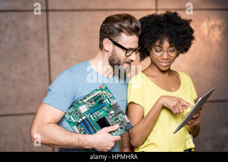 Programmers with computer motherboard Stock Photo