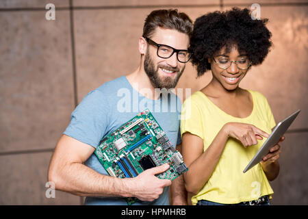 Programmers with computer motherboard Stock Photo