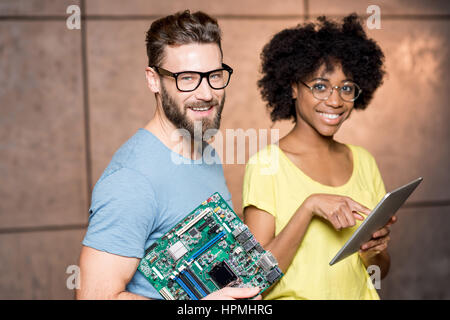 Programmers with computer motherboard Stock Photo