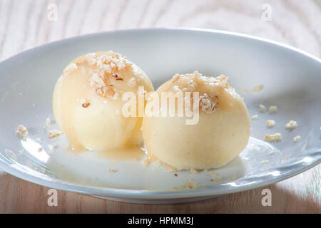 closeup photo of gnocchi on plate covered with melted nuts in sweet sauce Stock Photo