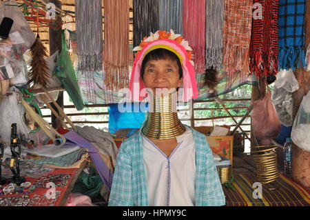 Padaung long-neck woman in front of her souvenir stall in Karen village, Chiang Mai, Thailand Stock Photo