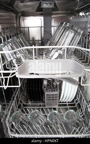 Clean glasses and plates in a modern dishwasher machine Stock Photo