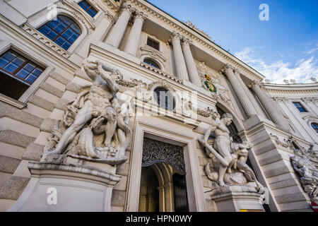 Austria, Vienna, monumental Hercules statues depicting scenes of the classical mythology are flanking the gate of the St. Michael's Wing at the Vienna Stock Photo