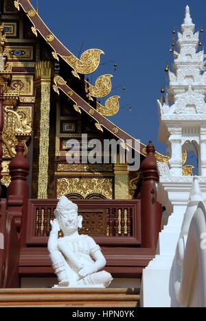 White Lanna style Thai sleeping guardian statue in front of  Hor Kham Luang in The Royal Flora Ratchaphruek Garden, Chiang Mai, Thailand
