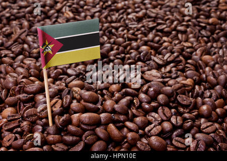 Flag of Mozambique sticking in roasted coffee beans.(series) Stock Photo