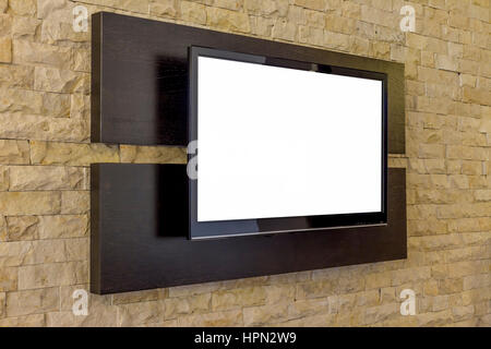 TV display on new brick wall background.  Modern living room interior - TV on brick wall Stock Photo