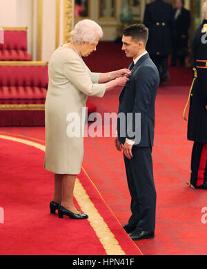 Gold medal winning Olympic gymnast Max Whitlock receives his Member of the Order of British Empire (MBE) medal from Queen Elizabeth II during an Investiture ceremony at Buckingham Palace, London. Stock Photo