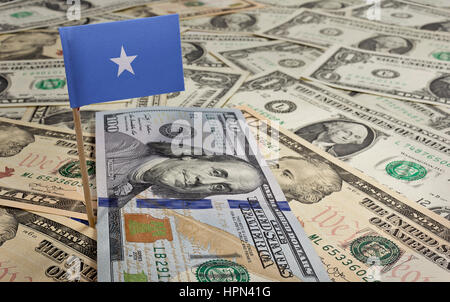 Flag of Somalia sticking in a variety of american banknotes.(series) Stock Photo