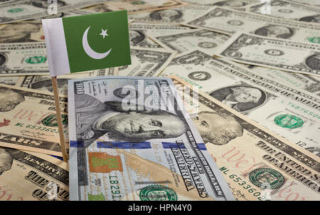 Flag of Pakistan sticking in a variety of american banknotes.(series) Stock Photo