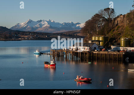 Portree Harbour with backdrop of Cuillins, Isle of Skye, Scotland Stock Photo