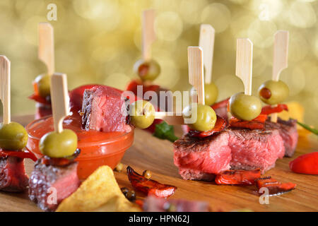 Medium fried steak tapas with chili, peppers and hot dip sauce Stock Photo