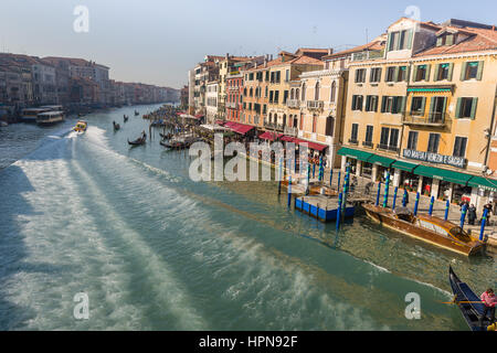 The view along the grand canal in venice, Italy, seen from the Rialto Bridge as a water ambulance speeds past leaving a wake behind Stock Photo