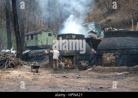 Klokocevac, Serbia - March 24, 2016: The production of charcoal in a traditional manner in the forest using beech wood Stock Photo