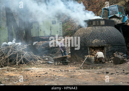 Klokocevac, Serbia - March 24, 2016: The production of charcoal in a traditional manner in the forest using beech wood Stock Photo